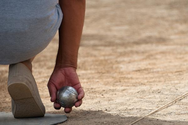 Petanque player ready to shoot