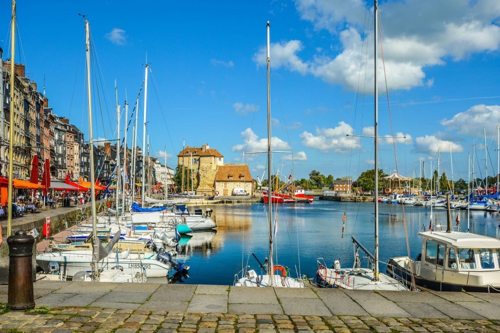 honfleur and its basin filled with boats on a sunny day during your spa and restaurant stay in our hotel in Normandy